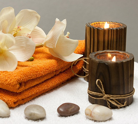 Calm spa ambience with candles and towels